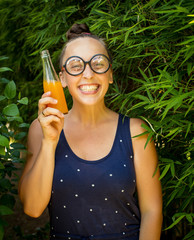 nerd girl with a bottle of juice