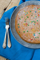 A delicious carrot cake on a plate lying on gray. 