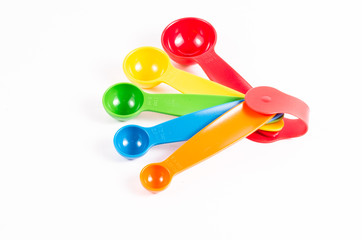 colorful measuring spoons isolated on white background