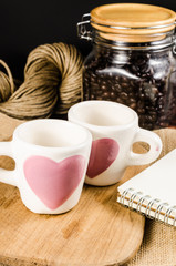 Fototapeta premium Two coffee cup on wooden board and coffee bottle with back backg