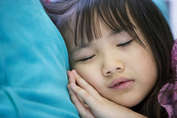 Adorable little girl sleeping in a bed