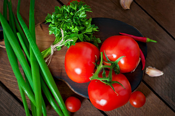 Branch of fresh tomato on wooden background