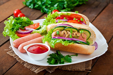 Hotdog with ketchup, mustard, lettuce and vegetables 