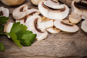 Fresh Organic mushrooms champignons on wooden background 