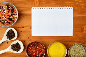 Copyspace food frame with notepad spices and cooking accesories