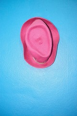 Pink vintage hat on blue vintage wall