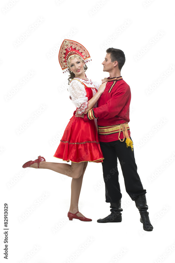 Wall mural Couple of dancers in russian traditional costumes, embracing