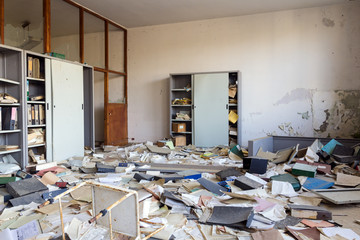 Abandoned office with many papers on the floor
