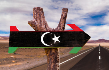 Libya Flag wooden sign with desert road background