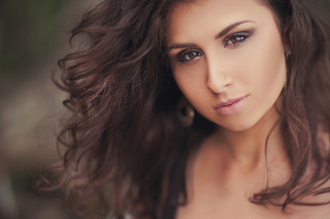Portrait of a beautiful brunette girl on the nature