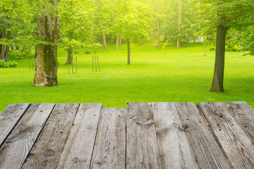 View from wooden table to the green bokeh background