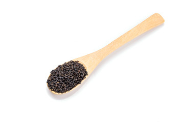 Heap of black sesame on wooden spoon