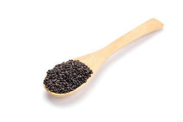 Heap of black sesame on wooden spoon