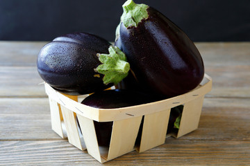 Raw eggplant in a wooden box