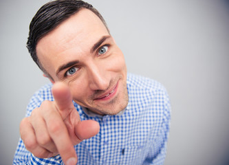 Funny man pointing finger on camera