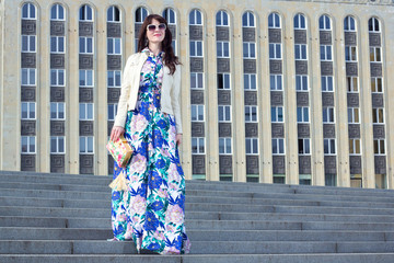 portrait of beautiful business woman posing over big building