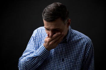 Man covering his mouth with hands