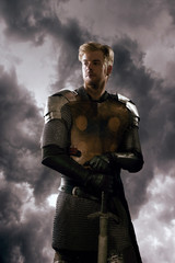  Ancient knight in metal armor with sword 
