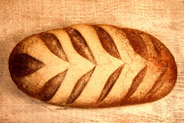  fresh baked bread with scattered flour on wooden background