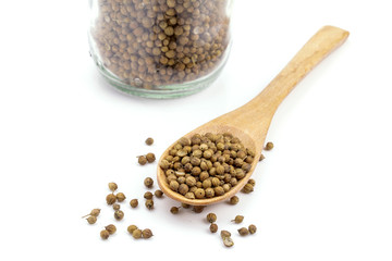 coriander seeds in a wooden spoon