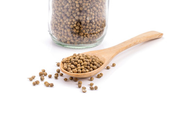 coriander seeds in a wooden spoon