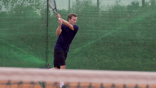 Professional Tennis Player Hits The Ball And Expresses Achievement