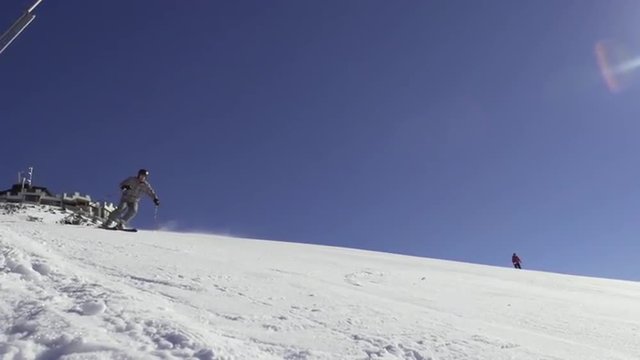 Slow Motion Of A Professional Skier Carving Downhill With Sun Shining