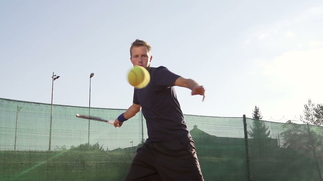 Young Professional Tennis Player Hits The Ball With Forehand Stroke