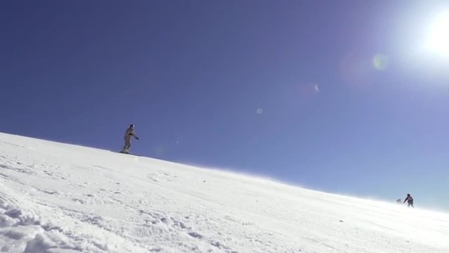 Slow Motion Wide Shot Of A Professional Skier Carving Downhill The Steep Terrain