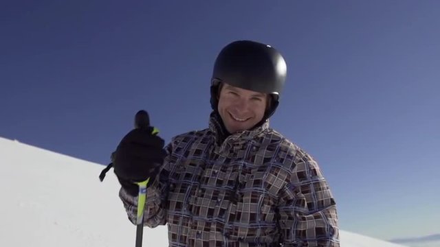 Slow Motion Portrait Shot Of Male Skier Lifting Thumb Up At Camera