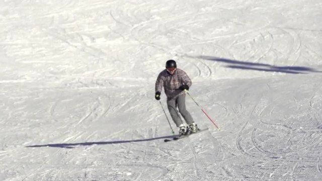 Slow Motion Wide Shot Of Skier Skiing Down The Ski Track During Winter Holidays