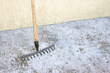 Rake tool over concrete background