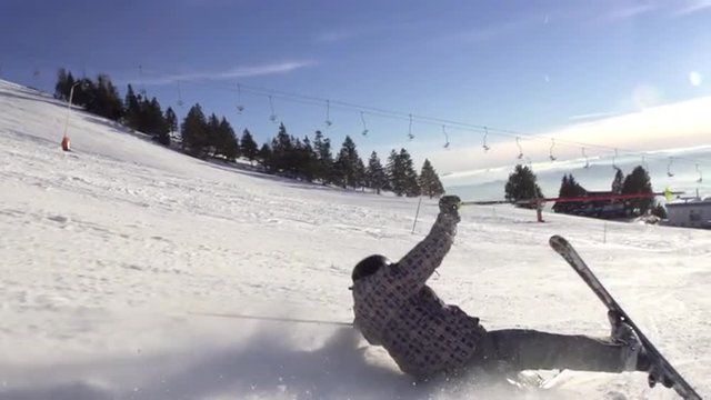 Slow Motion Shot Of Skier Falling Hard And Drifting Down The Ski Track