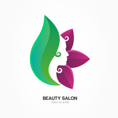 Beautiful woman's profile face in purple and green flower leaves