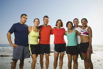 Multi-ethnic runners at beach