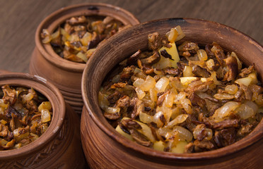 Baked potatoes with mushrooms in pot