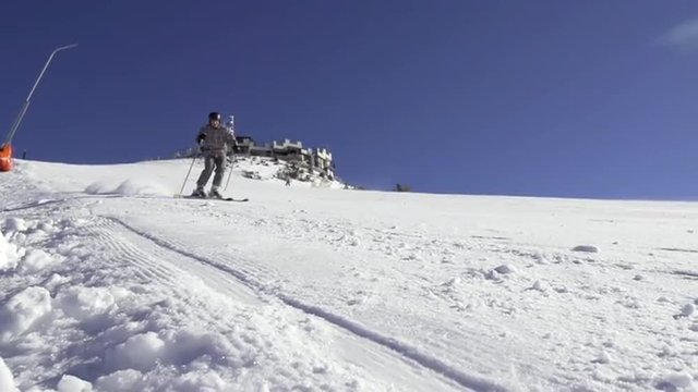 Beautiful Sun Flared Slow Motion Of Skier Carving Down The Ski Track
