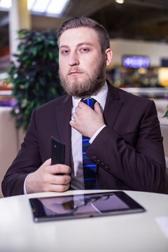 Businessman looking, phone, board, tie