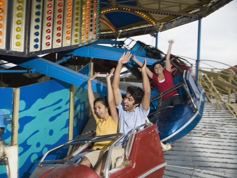 Multi-ethnic teenaged friends on carnival ride