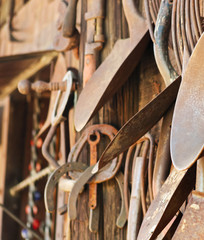 A Rustic Wooden Wall of Rusty Tools