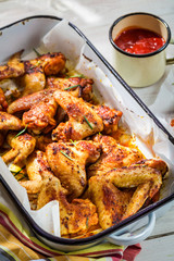 Crispy chicken wings with herbs and sauce