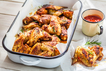 Hot chicken wings in summer kitchen