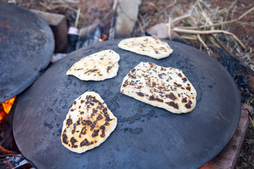 Pita bread baking on a Saj or Tava