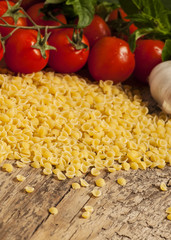 Italian dry pasta coccioline in the shape of seashells wooden ta