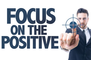 Business man pointing the text: Focus on the Positive