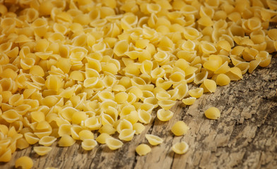 Italian dry pasta coccioline in the shape of seashells wooden ta