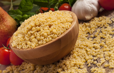 Italian dry pasta coccioline in the shape of seashells wooden ta
