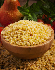 Italian dry pasta coccioline in the shape of seashells wooden ta