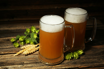Mug of beer on a brown wooden background