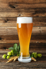 Glass of beer on a brown wooden background